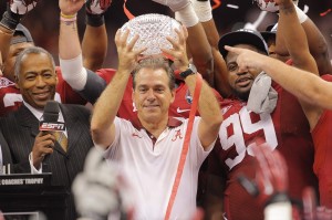 Alabama head coach Nick Saban holds up the Coaches Trophy