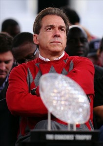 uspw_5917694_NickSaban Jan. 21, 2012; Tuscaloosa, AL, USA; Alabama Crimson Tide coach Nick Saban looks out at the crowd behind the Coaches' Trophy during the Alabama Football National Championship Celebration at Bryant-Denny Stadium. Photo Credit: Kelly Lambert-US PRESSWIRE