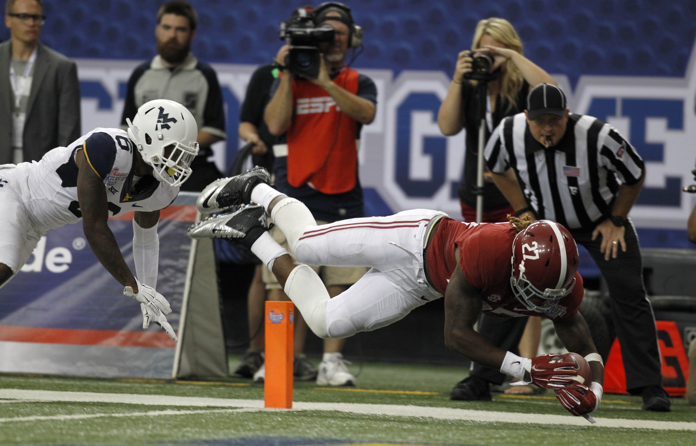 Aug 30, 2014; Atlanta, GA, USA; Alabama Crimson Tide running back Derrick Henry (27) dives in to the end zone to score a touchdown against West Virginia Mountaineers safety Dravon Henry (6) in the third quarter of the 2014 Chick-fil-A Kickoff Game at the Georgia Dome. Mandatory Credit: Brett Davis-USA TODAY Sports