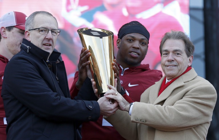 Jan 23, 2016; Tuscaloosa, AL, USA; Southeastern conference commissioner Greg Sankey holds the College Football Playoff trophy with Alabama running back Derrick Henry (2) and head coach Nick Saban during a presentation to celebrate the victory in the CFP National Championship game at Bryant-Denny Stadium. Mandatory Credit: Butch Dill-USA TODAY Sports