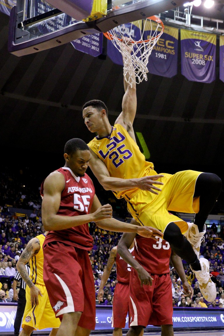Jan 16, 2016; Baton Rouge, LA, USA; LSU Tigers forward Ben Simmons (25) hangs on the rim after a dunk over Arkansas Razorbacks forward Keaton Miles (55) during the second half of a game at the Pete Maravich Assembly Center. LSU defeated Arkansas 76-74. Mandatory Credit: Derick E. Hingle-USA TODAY Sports