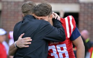 Nov 26, 2016; Oxford, MS, USA; Mississippi Rebels head coach Hugh Freeze embraces defensive end John Youngblood (38) before the game against the Mississippi State Bulldogs at Vaught-Hemingway Stadium. Mandatory Credit: Matt Bush-USA TODAY Sports